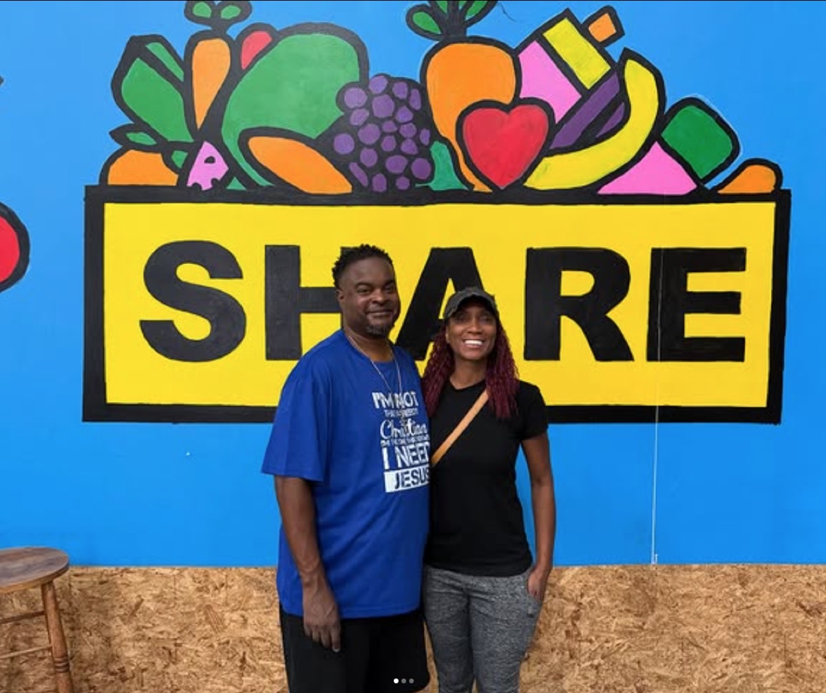 IMPACT Sports volunteers in front of a community SHARE food-program mural.